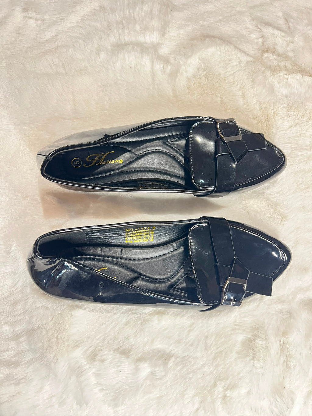 Black patent leather loafers with a bow