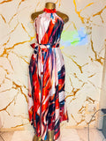 A sleeveless halter-neck maxi dress with a colorful abstract print