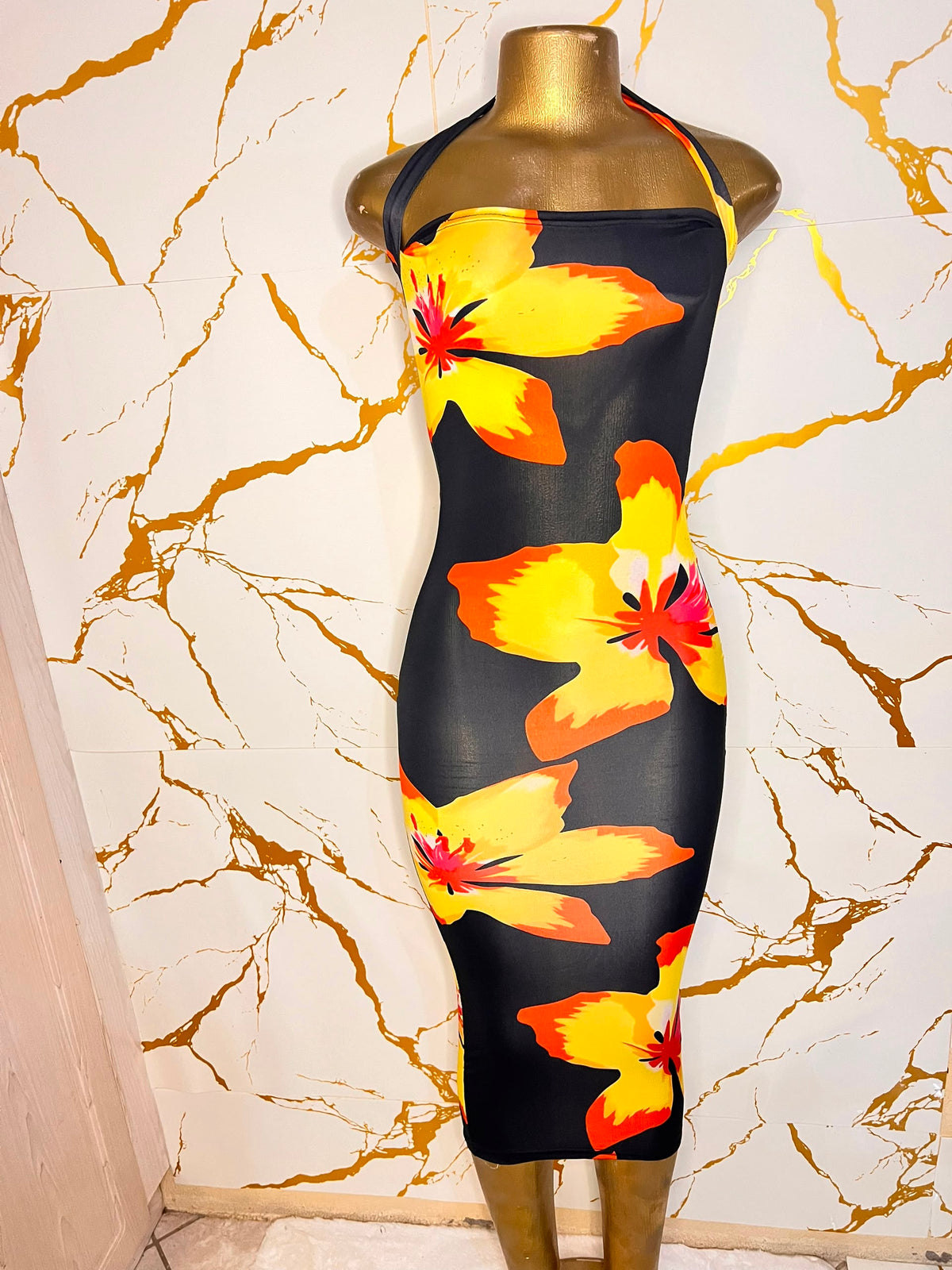 A black halter-neck bodycon dress