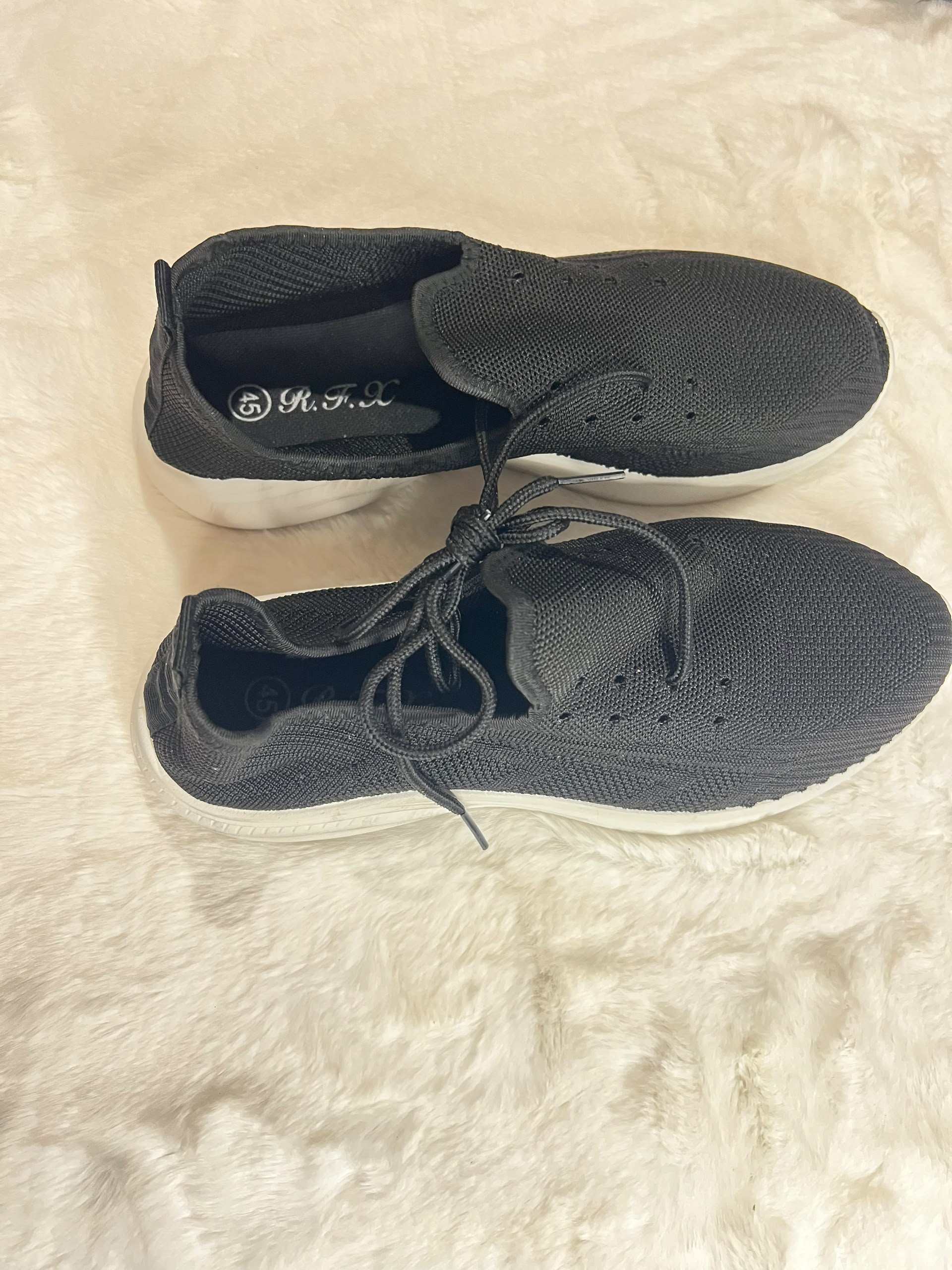 Black knit slip-on sneakers with white sole
