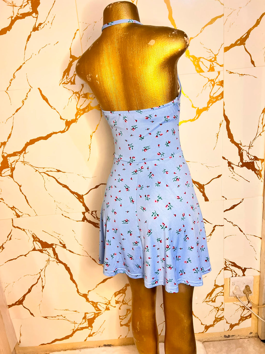 Light blue halter-neck mini dress with a small red and green floral print