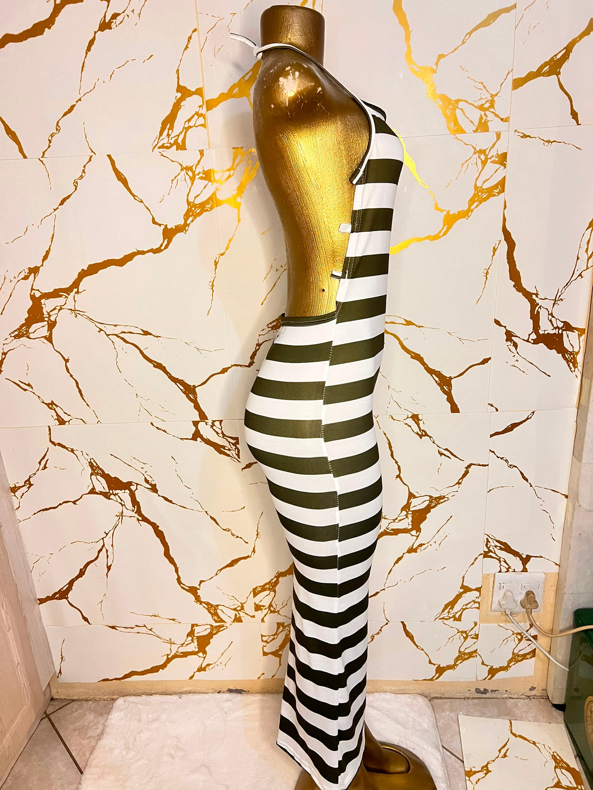 A sleeveless halter-neck maxi dress with horizontal black and white stripes