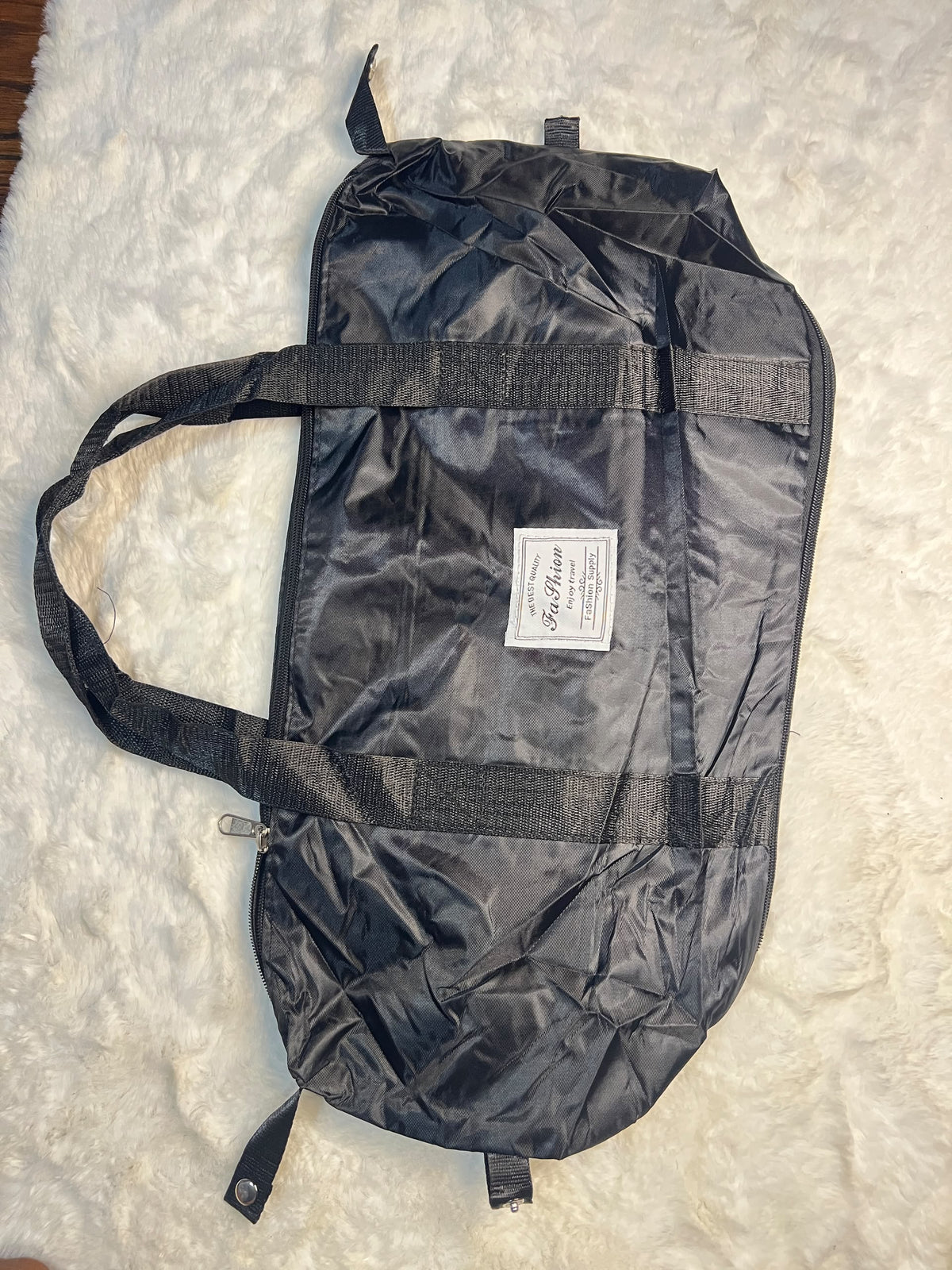 Black travelling zippered duffel bag with dual shoulder straps