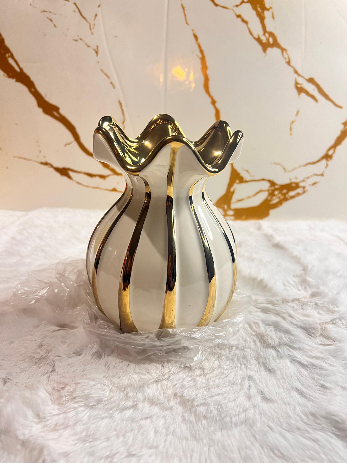 A decorative ceramic vase with a glossy white body