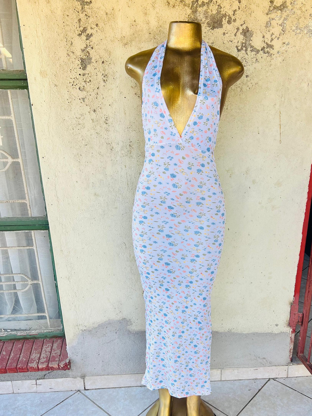 A sleeveless halter-neck maxi dress with floral patterns 