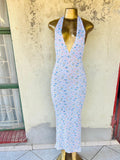 A sleeveless halter-neck maxi dress with floral patterns 