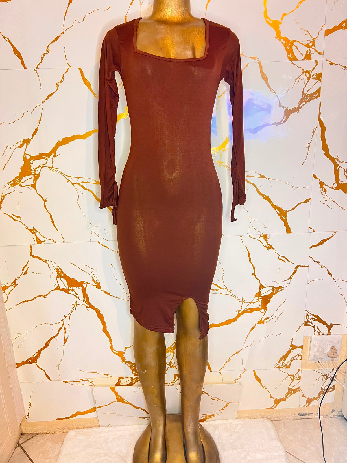 A sheer, long-sleeve bodycon dress in a deep reddish-brown 