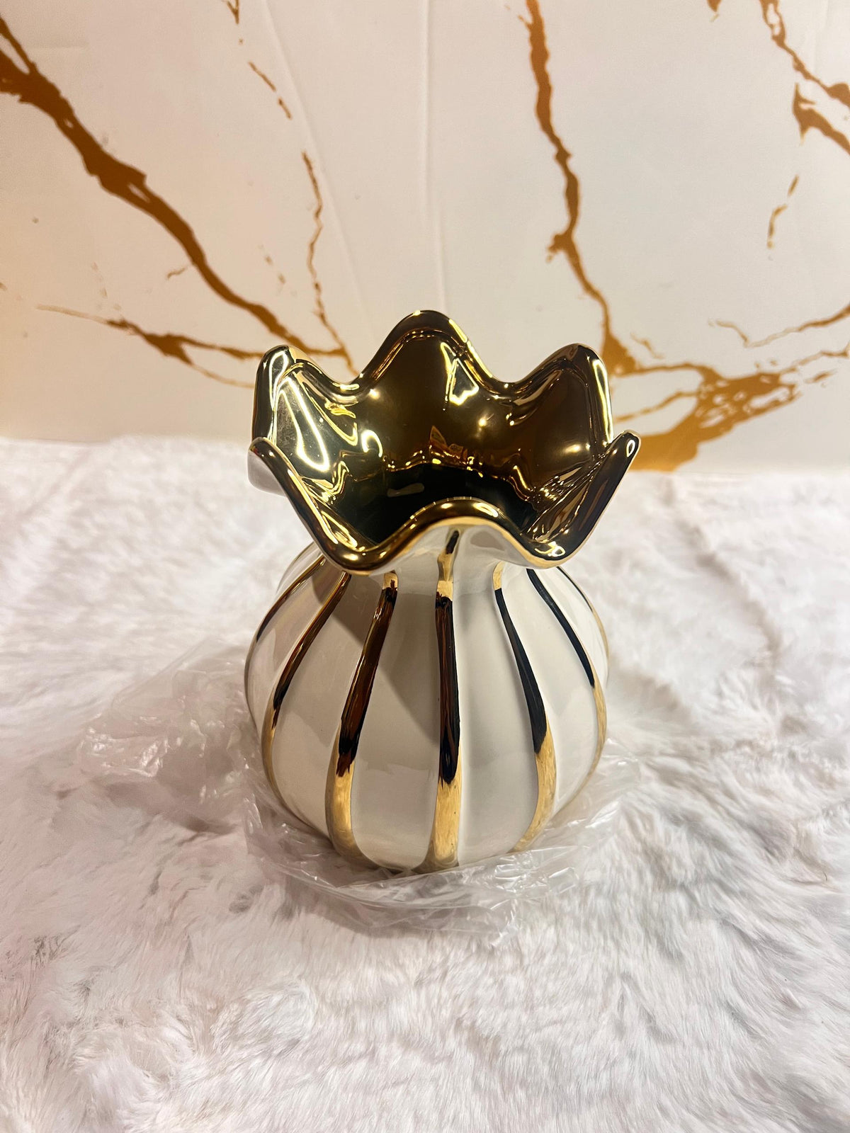 A decorative ceramic vase with a glossy white body