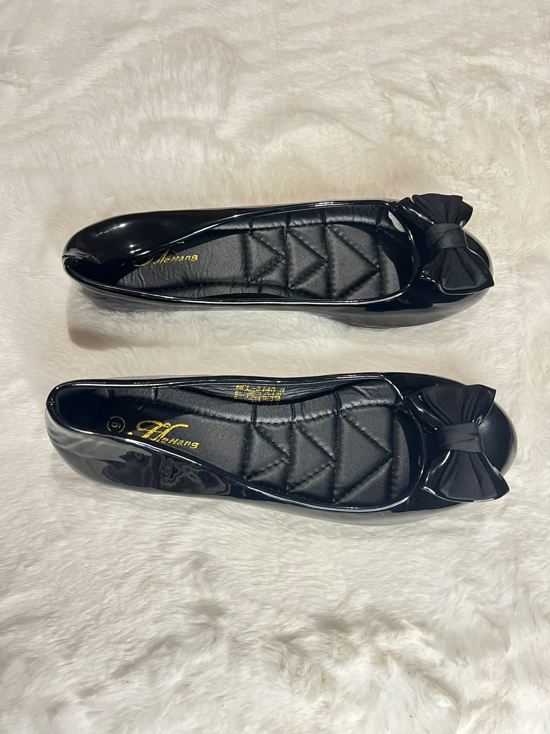 Black patent leather ballet flats with quilted insoles