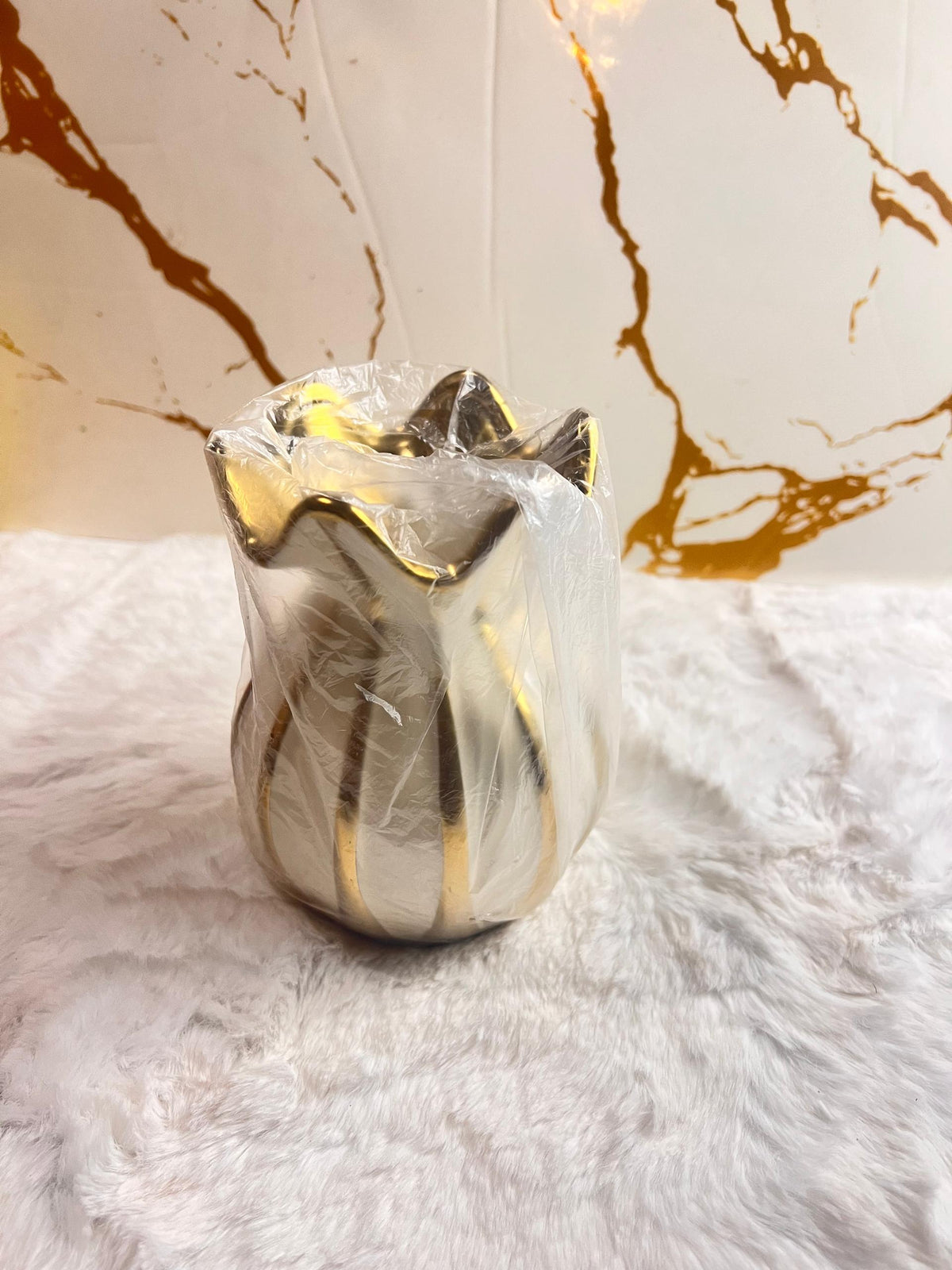 A decorative ceramic vase with a glossy white body