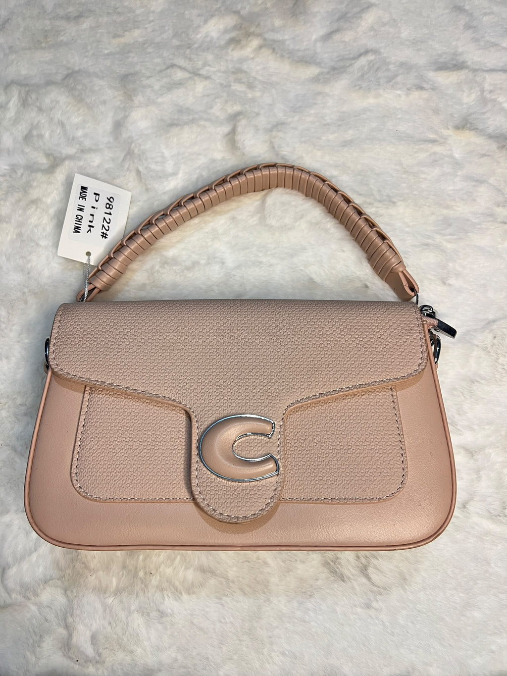 shoulder bag in a dusty pink pebbled leather with a textured flap