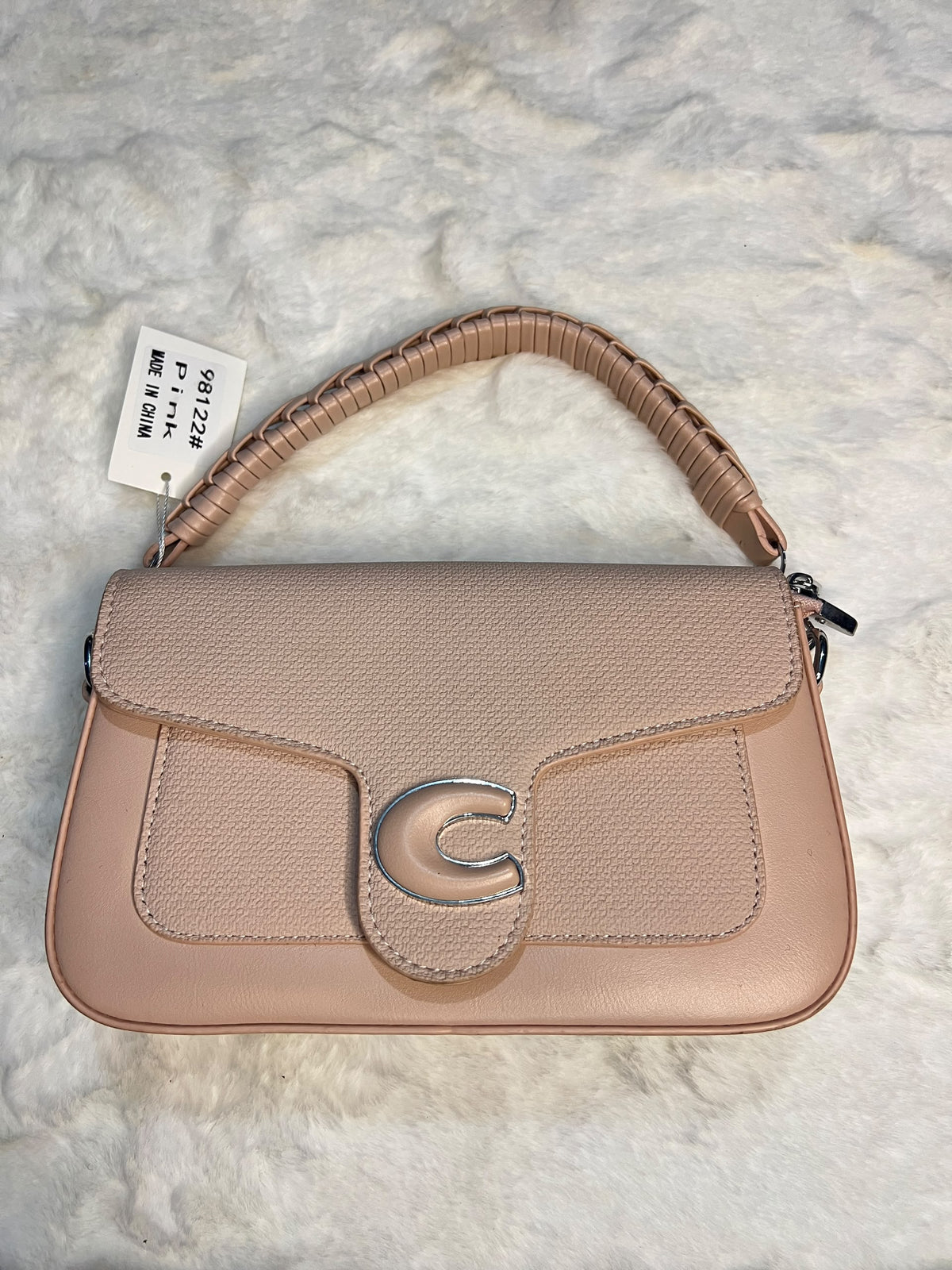 shoulder bag in a dusty pink pebbled leather with a textured flap