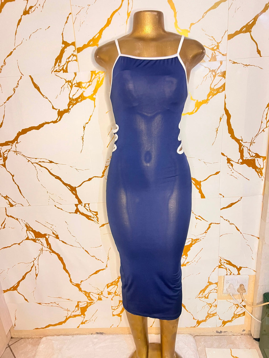 A navy blue bodycon midi dress with white trim and side cutouts