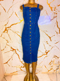 A blue denim midi dress with a button-down front and shoulder straps