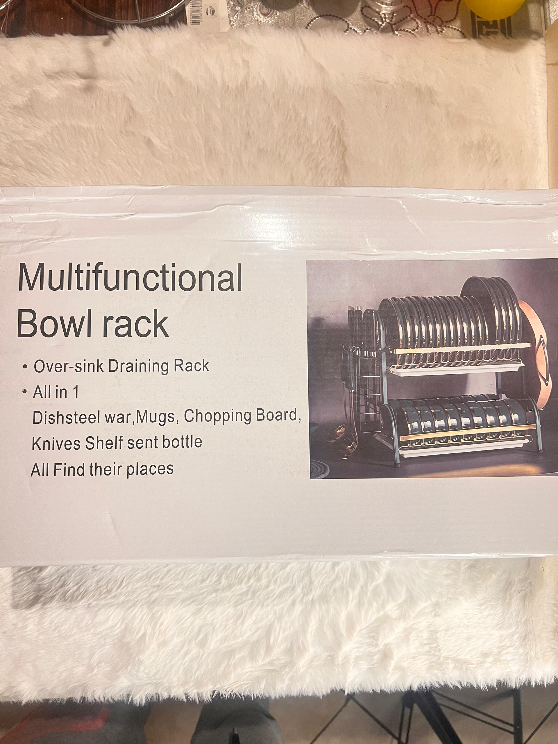 A boxed product labeled 'Multifunctional Bowl rack' with text describing features and a photo of the rack inside. 