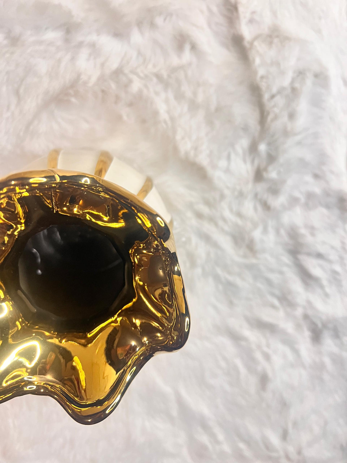 A decorative ceramic vase with a glossy white body