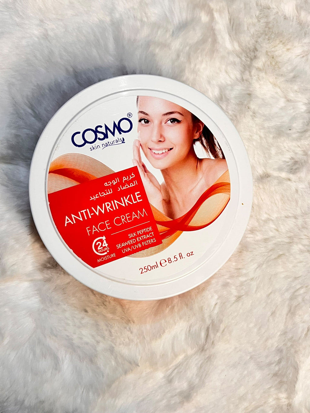 A round white tub of COSMO Skin Naturally Anti-Wrinkle Face Cream.