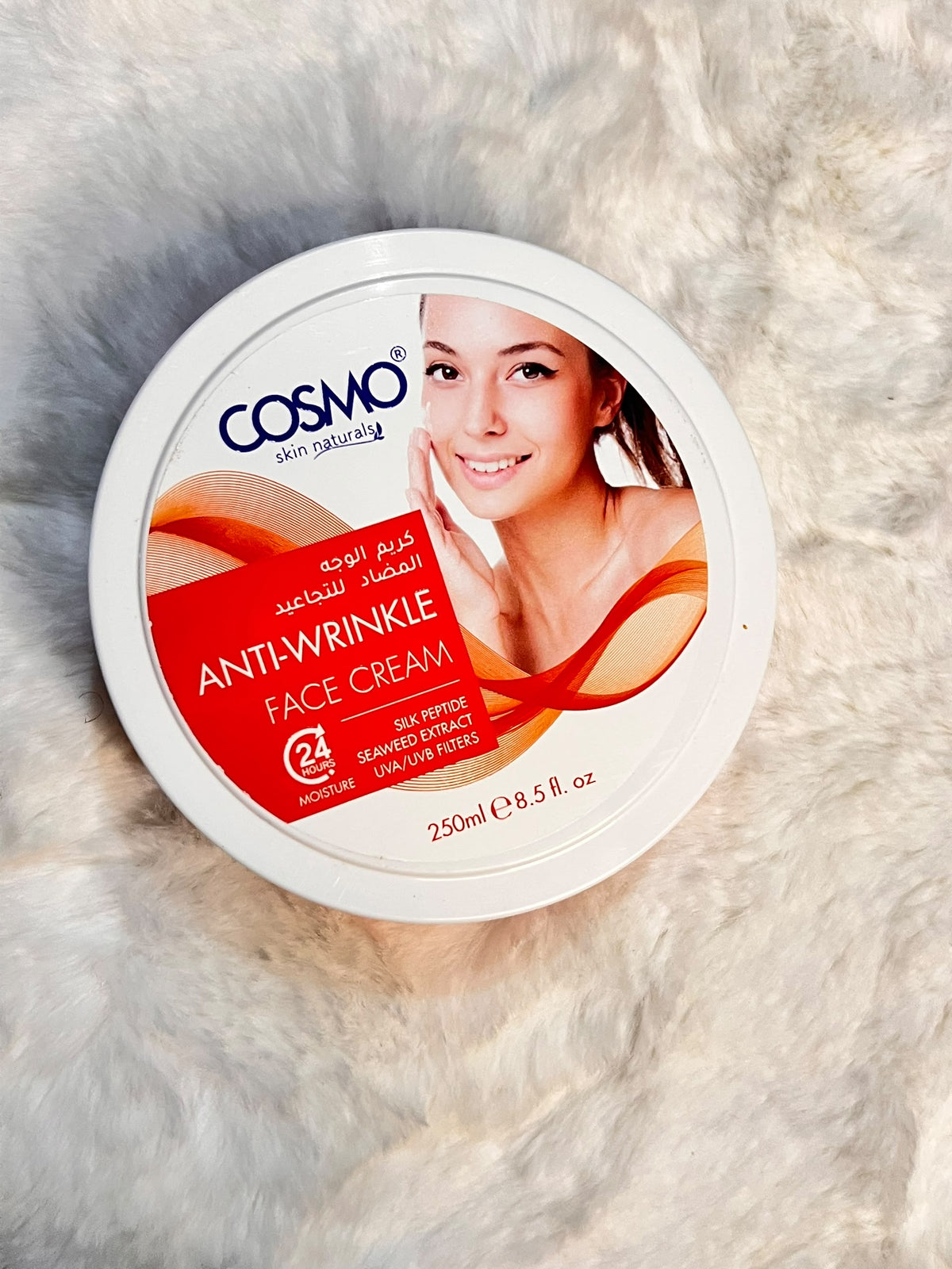 A round white tub of COSMO Skin Naturally Anti-Wrinkle Face Cream.