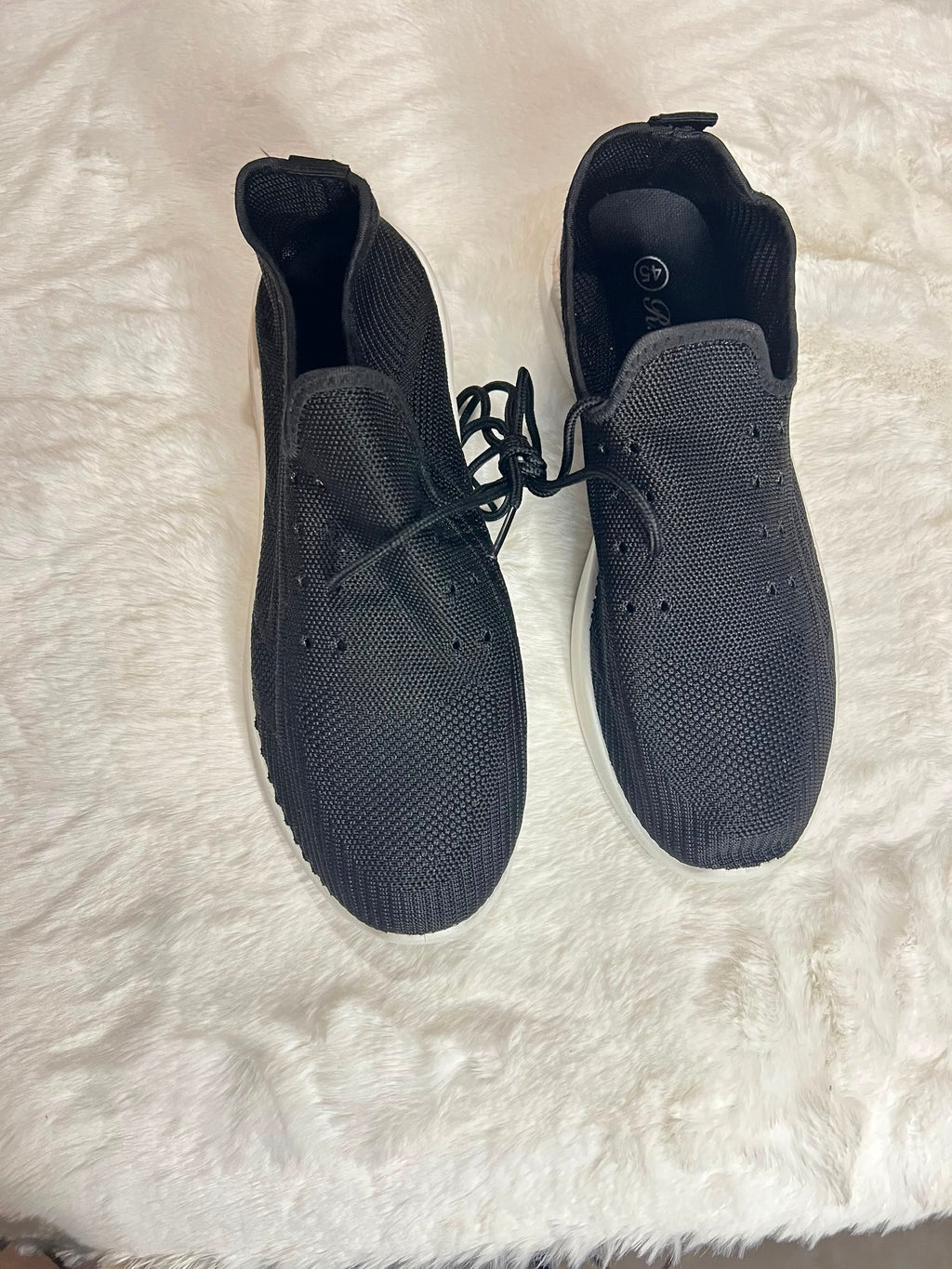 Black knit slip-on sneakers with white sole