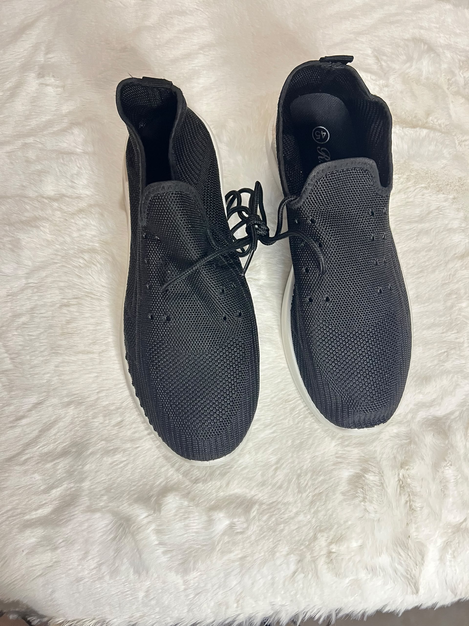 Black knit slip-on sneakers with white sole